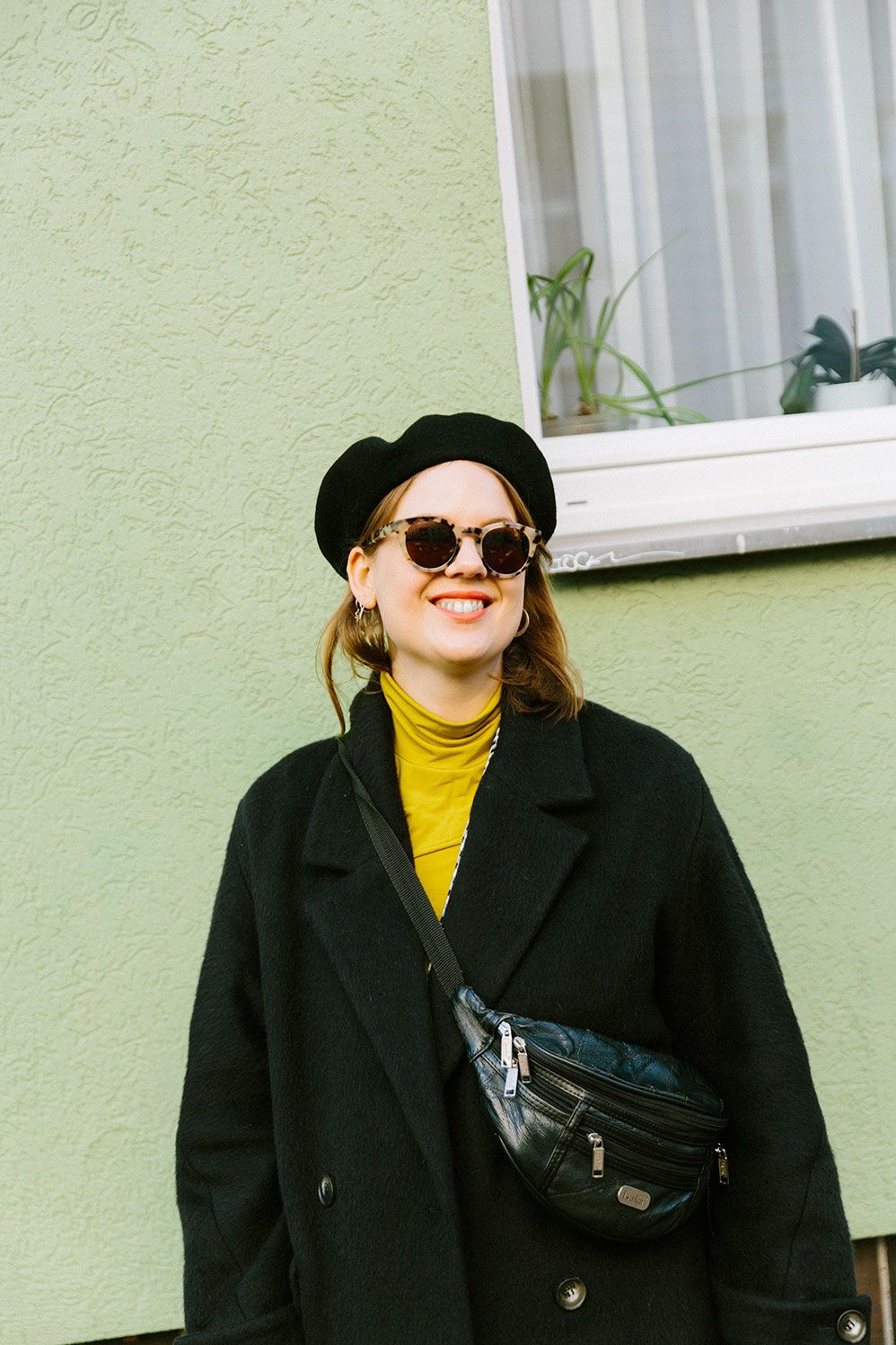 Berlin Feminist Film Week founder Karin Fornander in a beret and Ace & Tate glasses