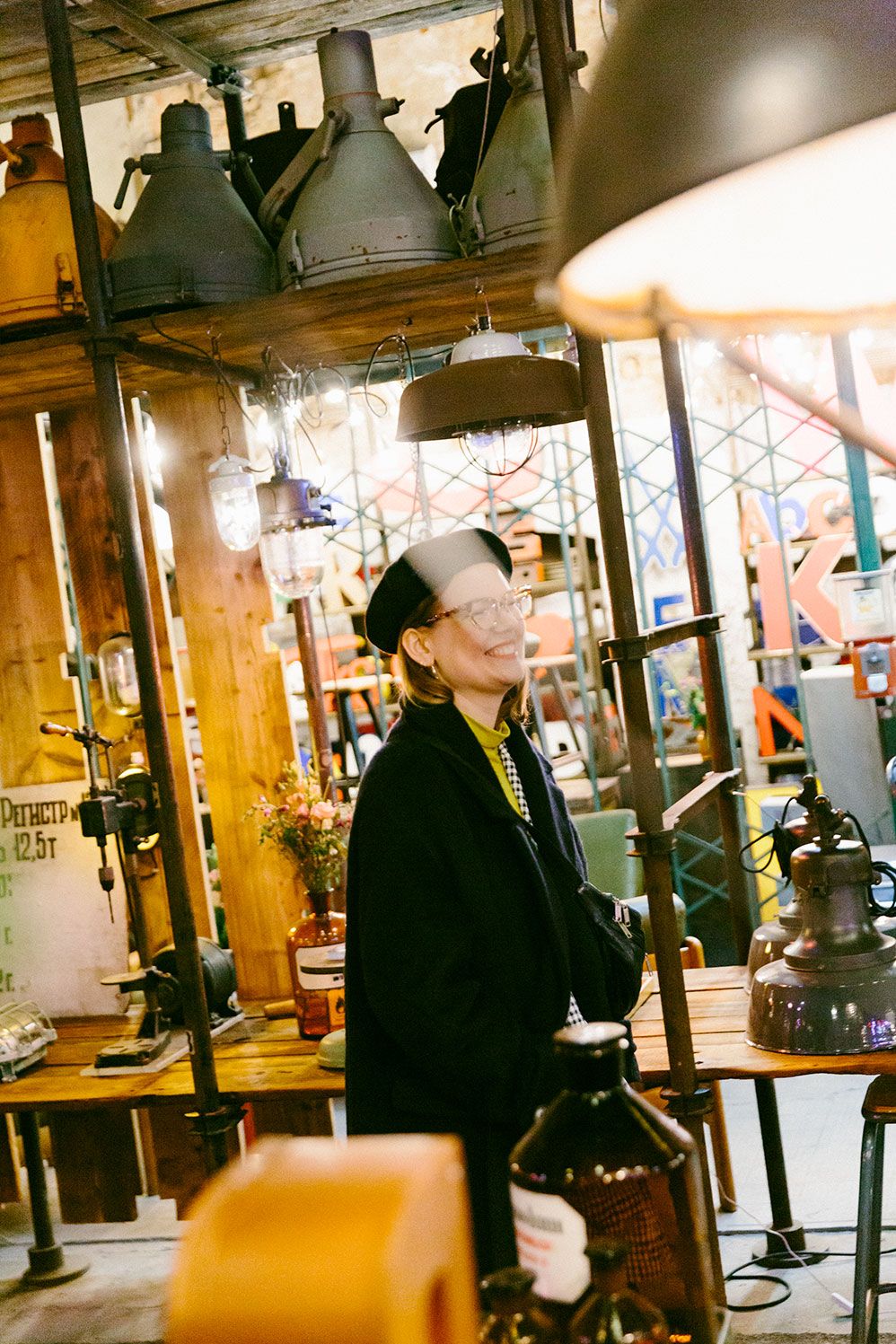 Karin Fornander browsing a shop full of lamps and objects