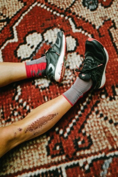 Cycling shoes and red socks on a patterned carpet, adidas Journeys lookbook