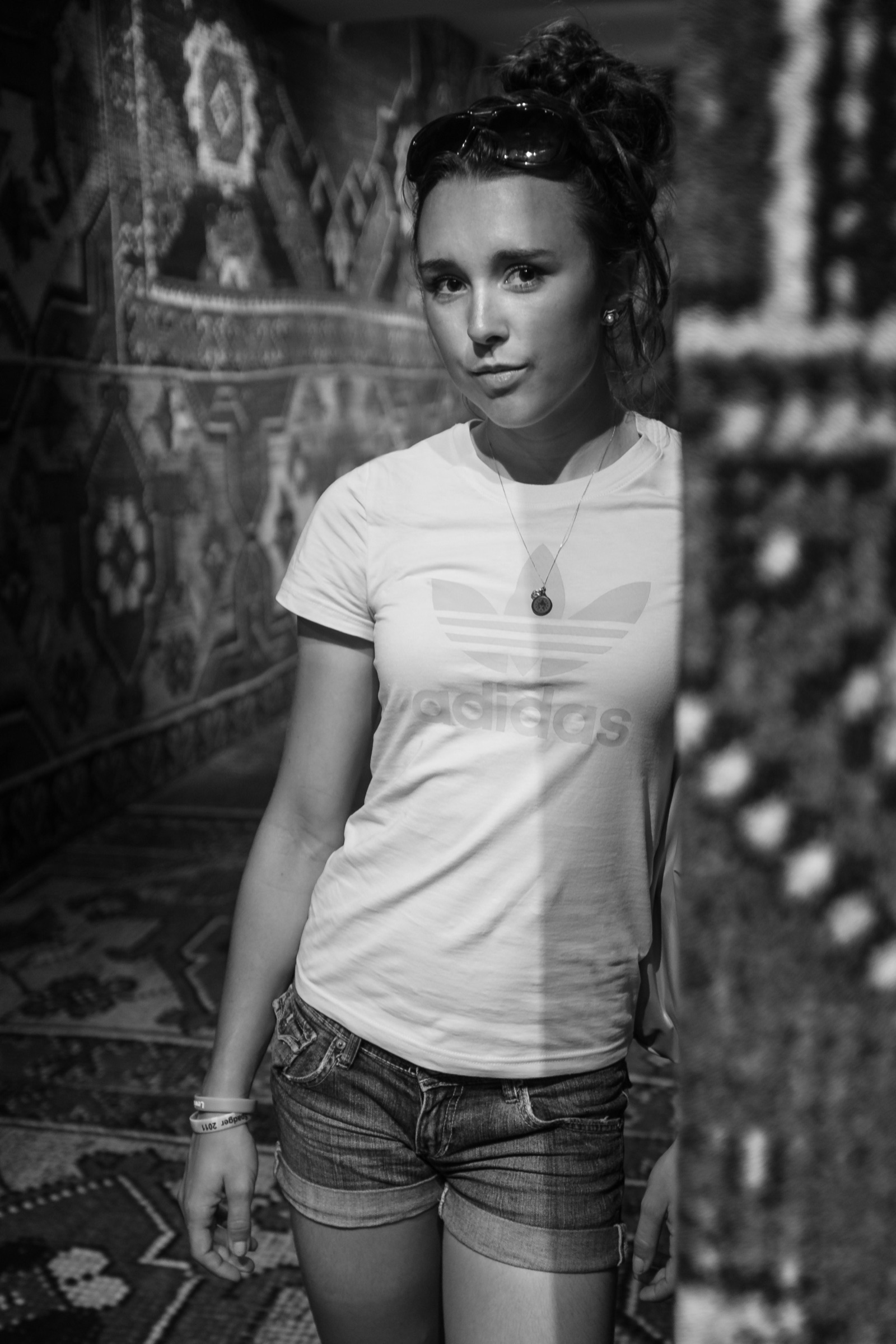Black and white portrait of an adidas Journeys team member against a patterned rug