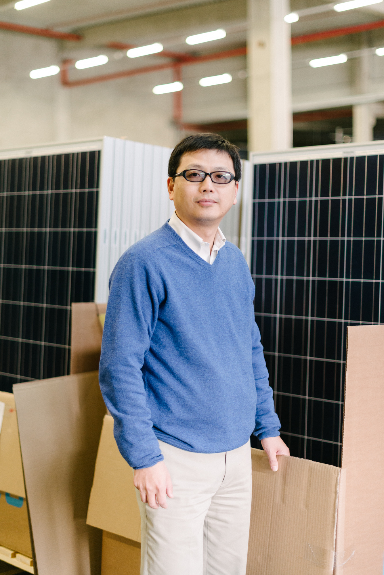 aleo solar employee standing between solar panels