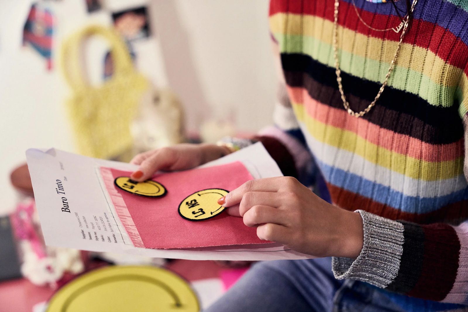 Hands holding a pink flyer with smiley stickers in an Amsterdam studio, ClassPass #bethebalance editorial