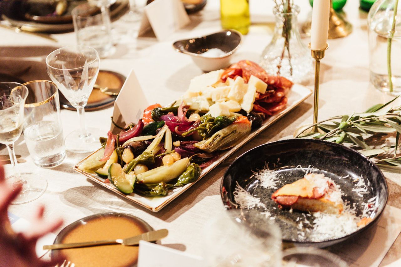Italian dishes and grilled vegetables on the dinner table