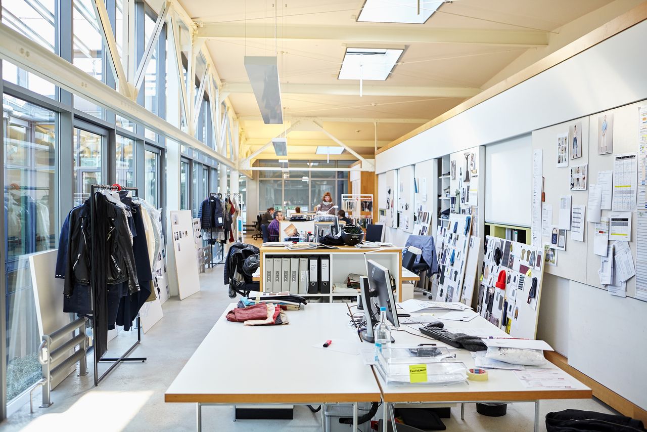 Open-plan design studio with mood boards and clothing rails at the CLOSED headquarters in Hamburg