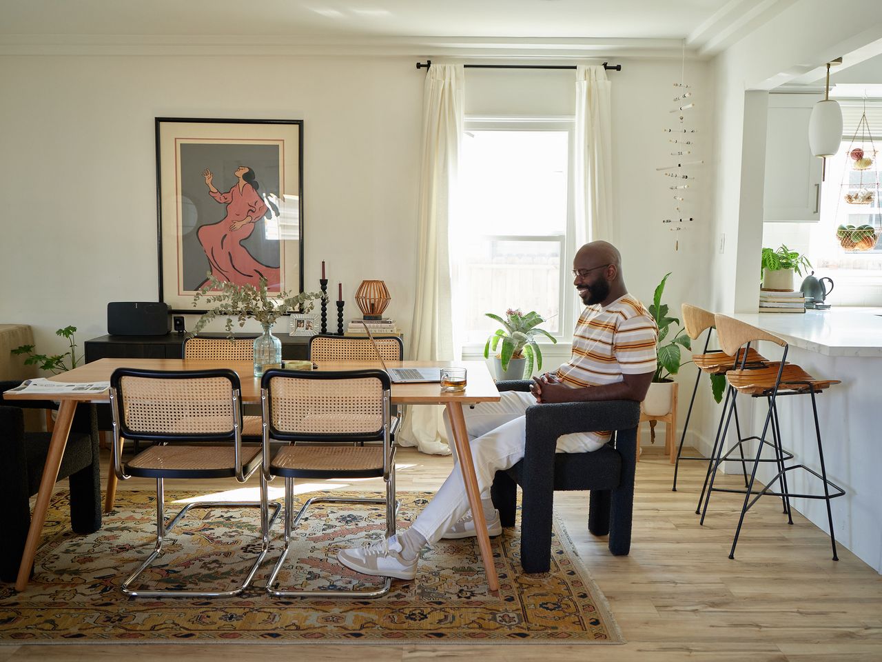Creative director at the table in the sunlit dining room of his 1920s home in South Los Angeles