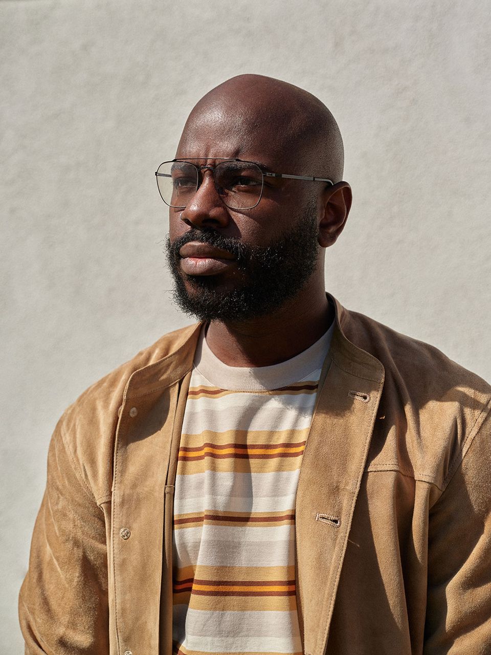 Creative director in a tan suede jacket and striped jumper, Los Angeles