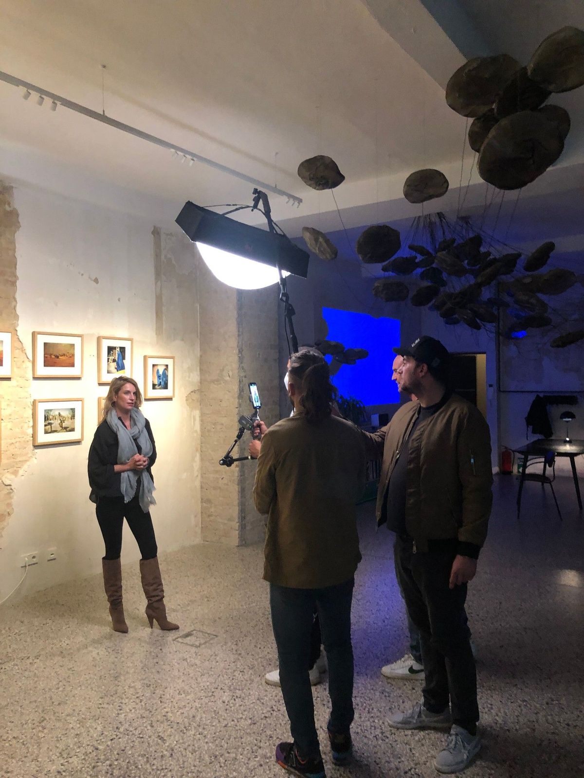 Camera crew filming a livestream walkthrough of a photo exhibition in the Friends Space