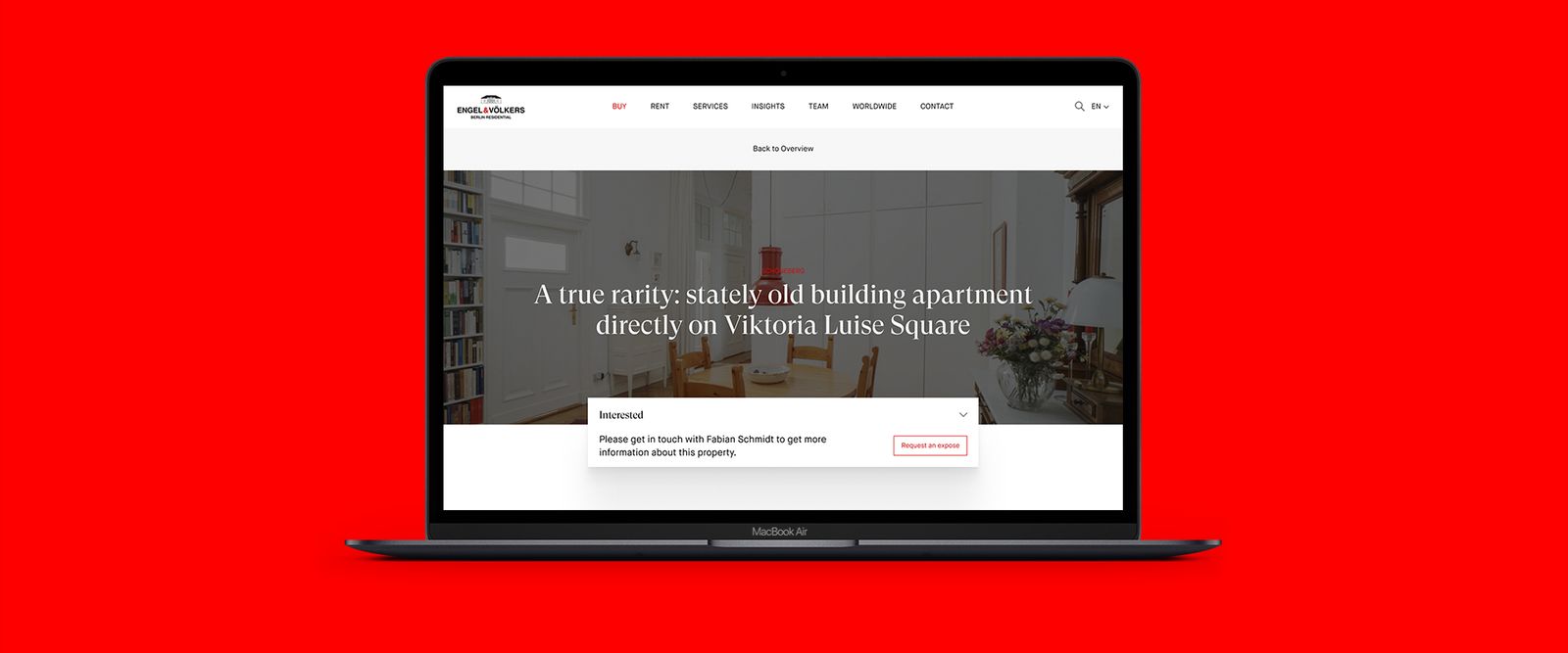 Engel & Völkers property page on a MacBook against a red background