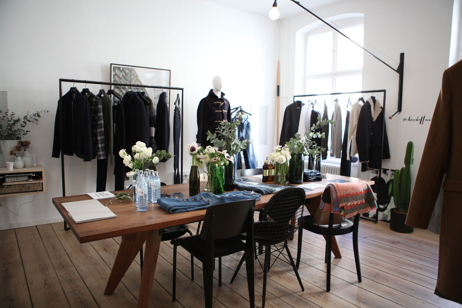 Clothing rails and a set table for a fashion collection presentation in the Friends Apartment