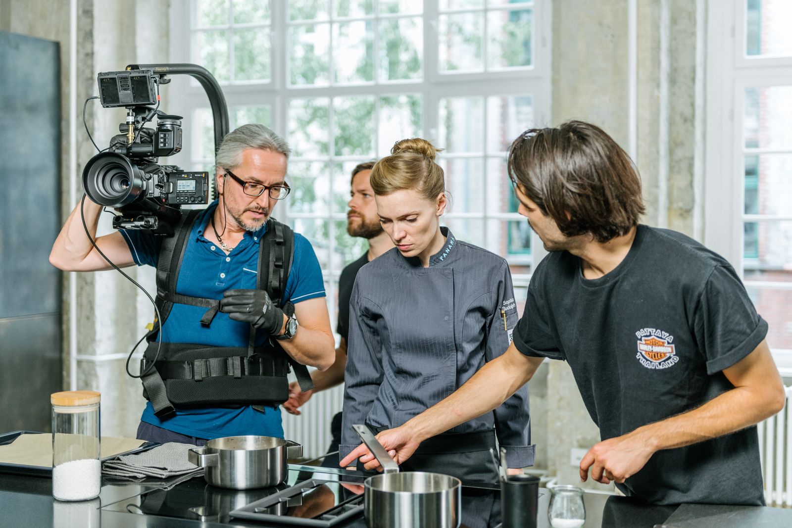 Film crew shooting a cooking scene at the open kitchen of the Friends Space
