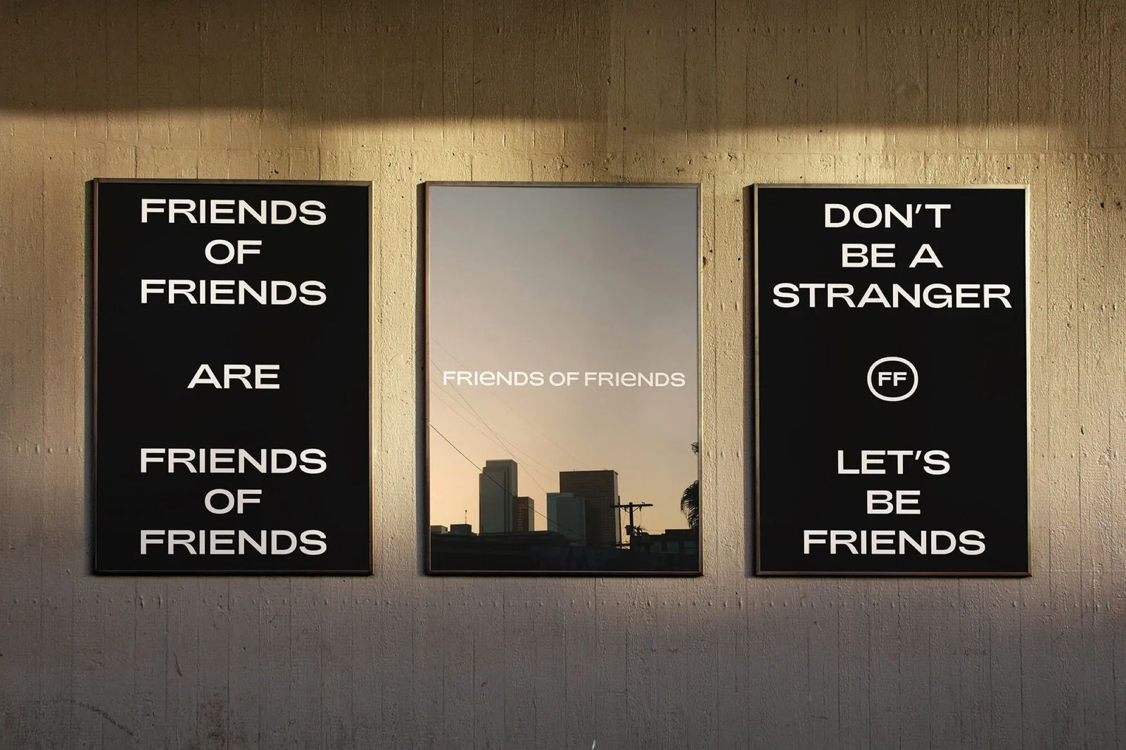 Three Friends of Friends posters on a lit wall