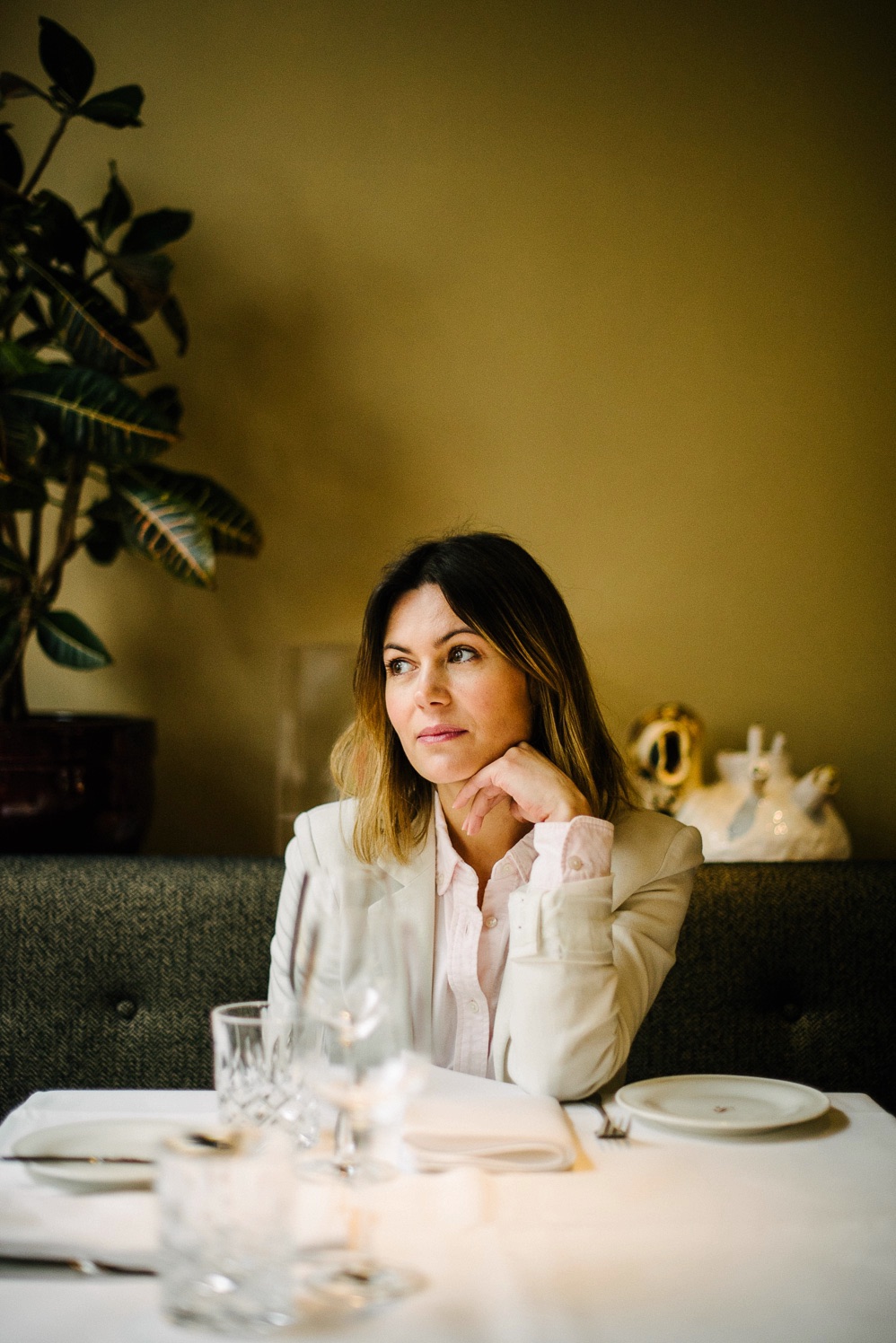 Woman seated at a table in the Le Petit Royal dining room