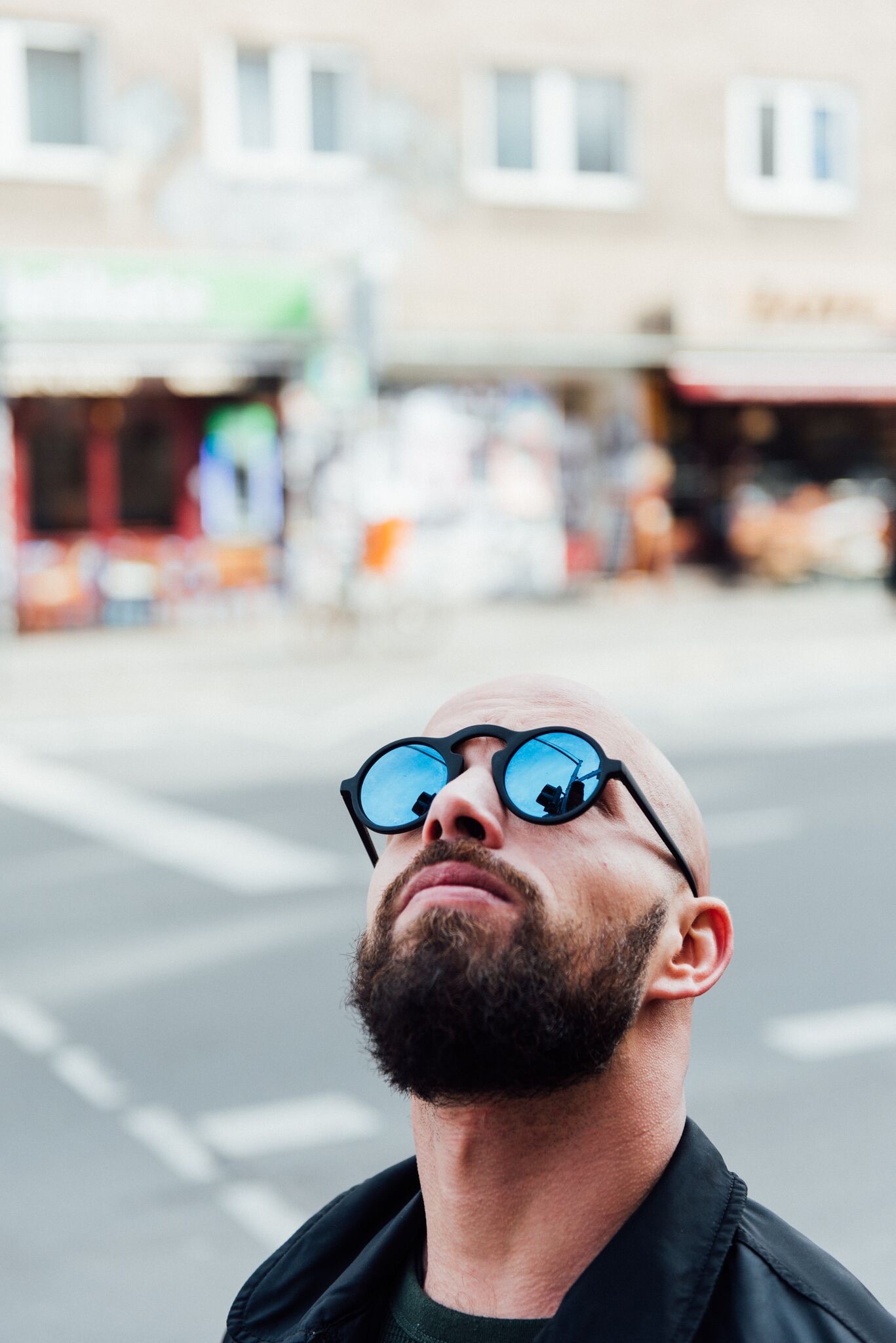 Berliner in round blue sunglasses looking up, You, Me & Berlin portrait for Hotel Berlin, Berlin
