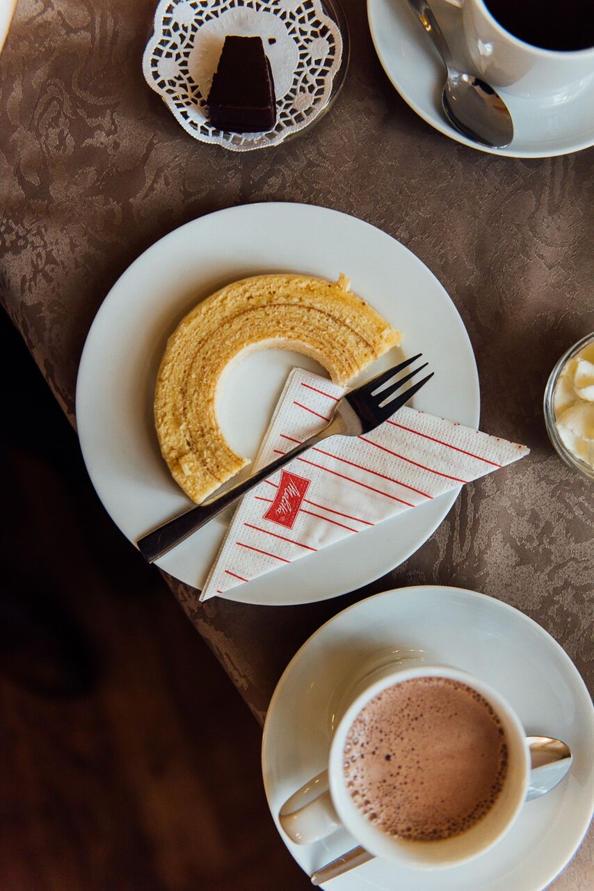 Coffee, hot chocolate and Baumkuchen on a Berlin café table, You, Me & Berlin campaign photography