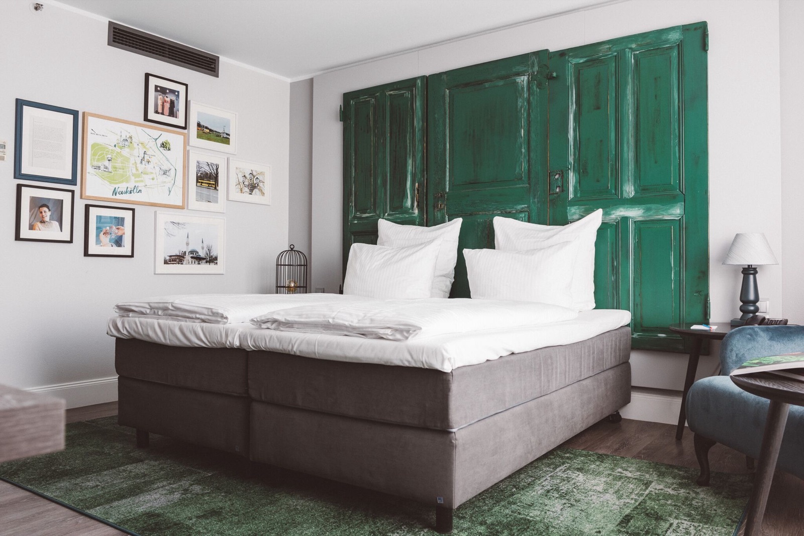 Hotel Berlin, Berlin room with green headboard and a gallery wall of framed Berlin prints