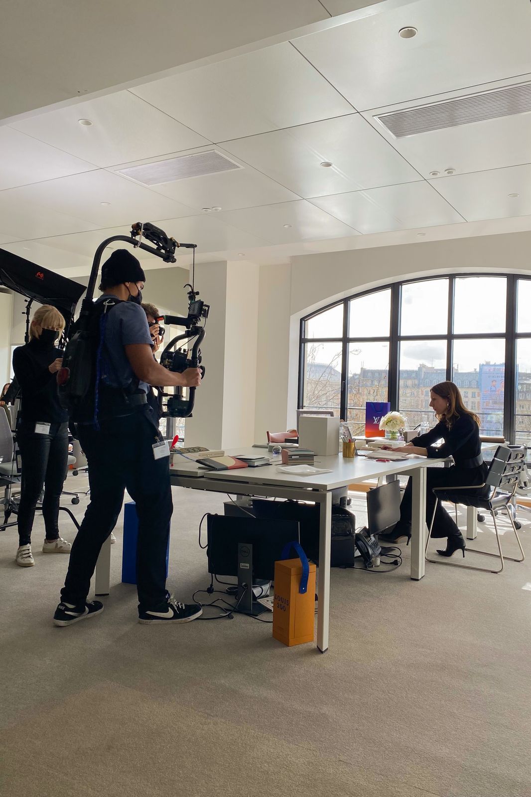 Behind the scenes: camera operator with a gimbal rig in a Paris office