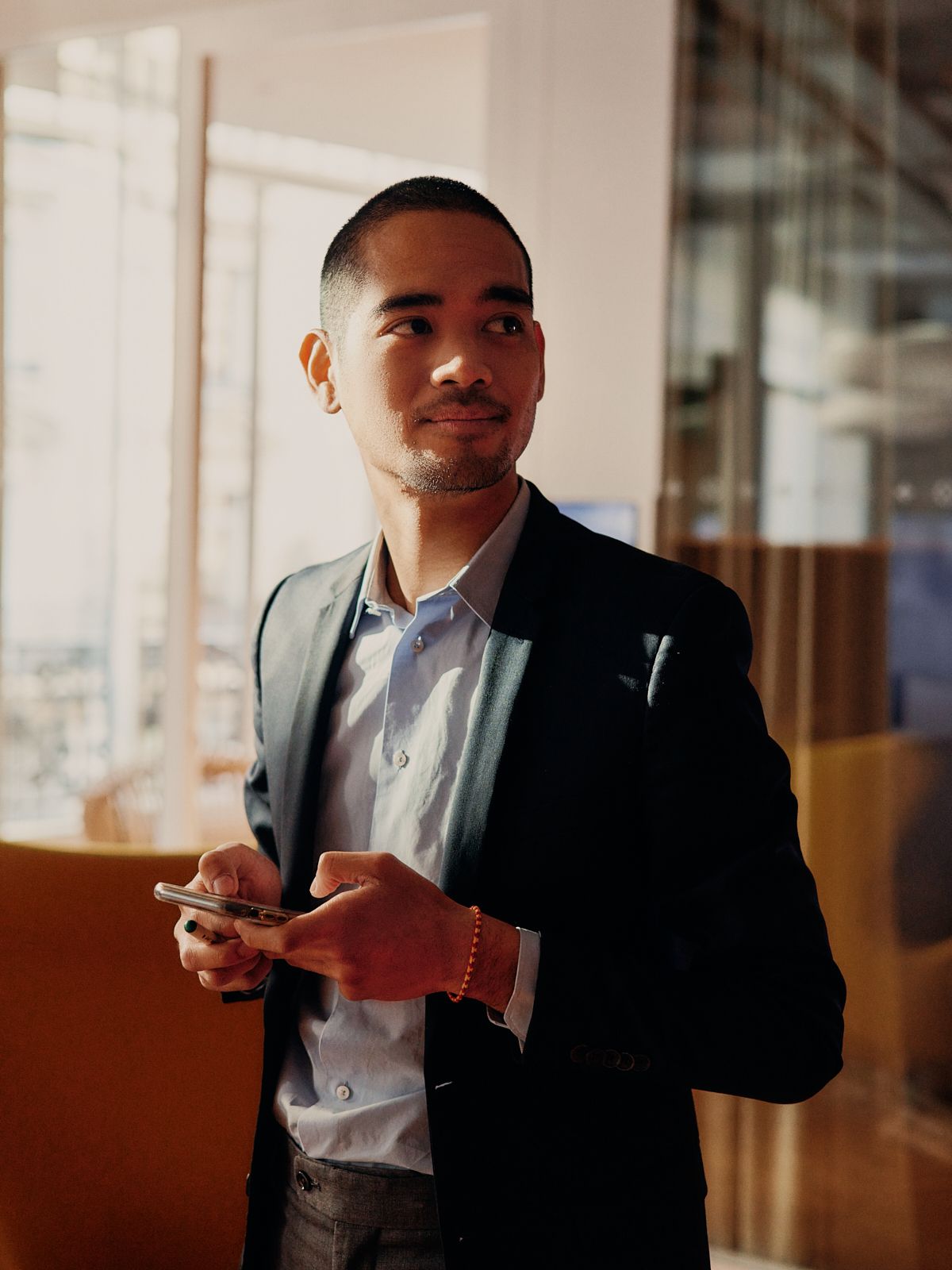 Portrait of a finance and audit employee in a dark suit at the office