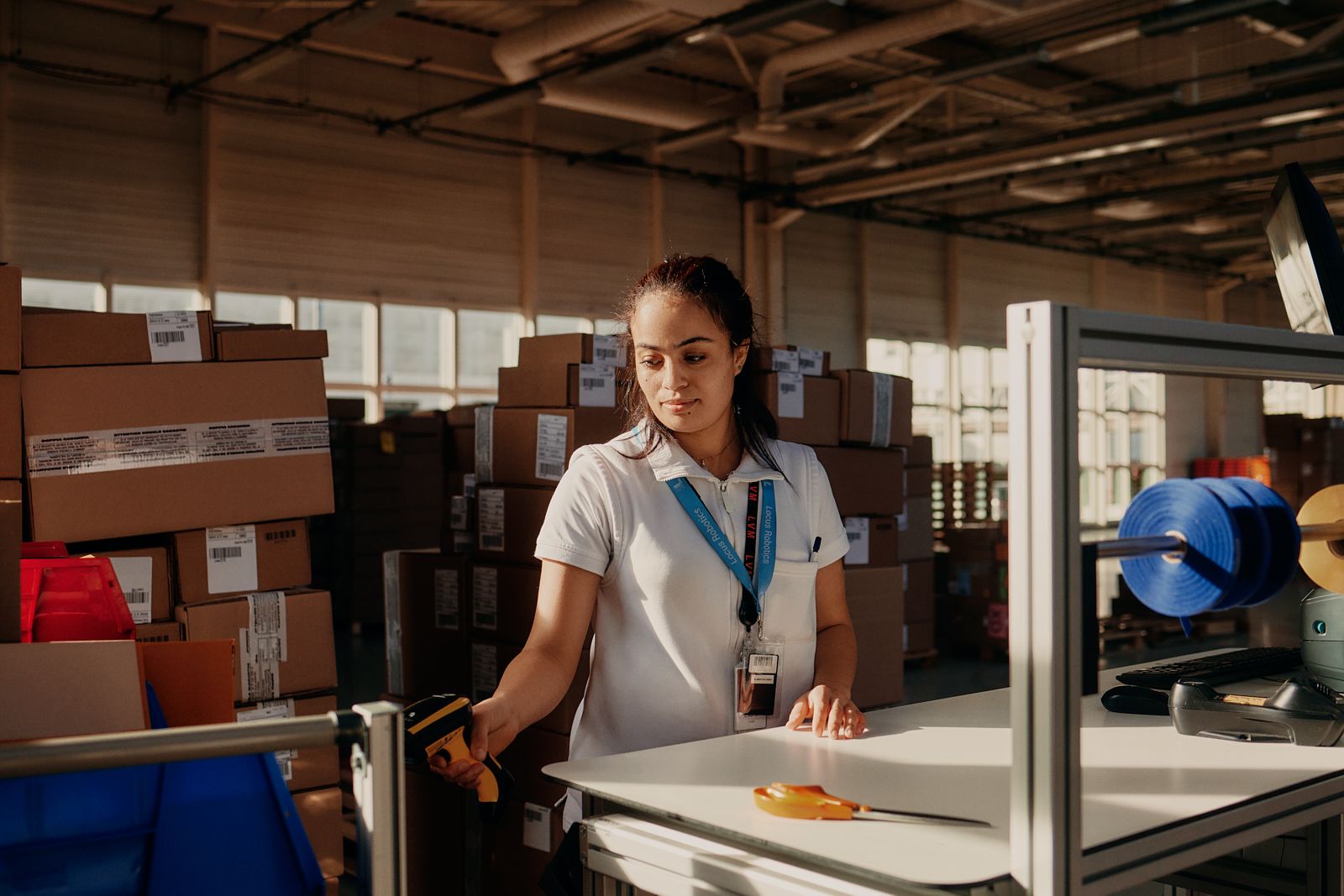 Louis Vuitton logistics employee scanning parcels in the Cergy warehouse