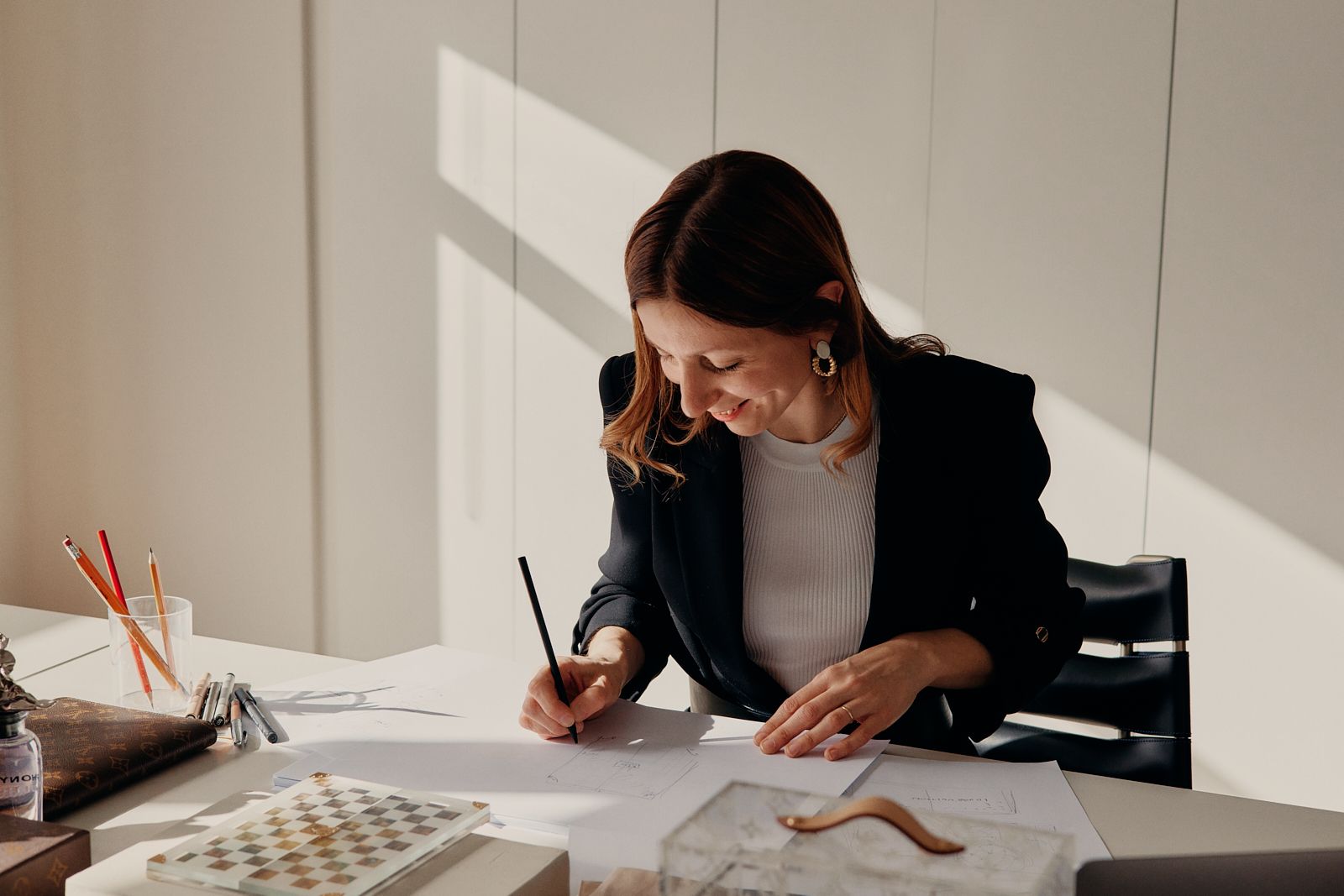 Procurement employee sketching at a white desk