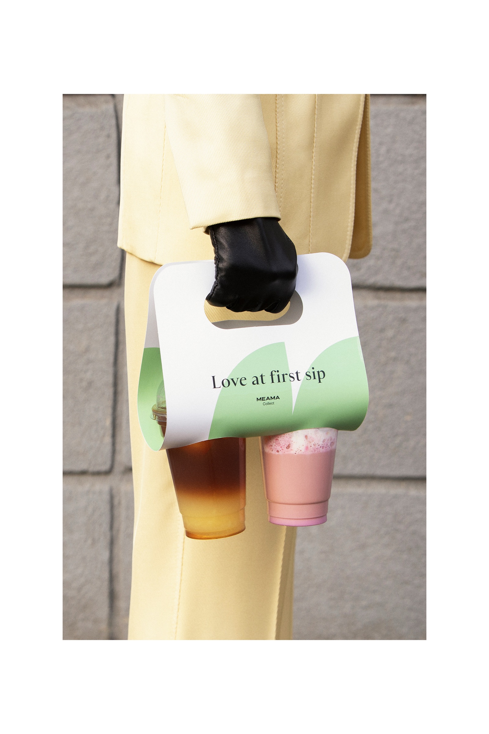 Meama poster of a hand carrying a Love at first sip cup carrier with two drinks
