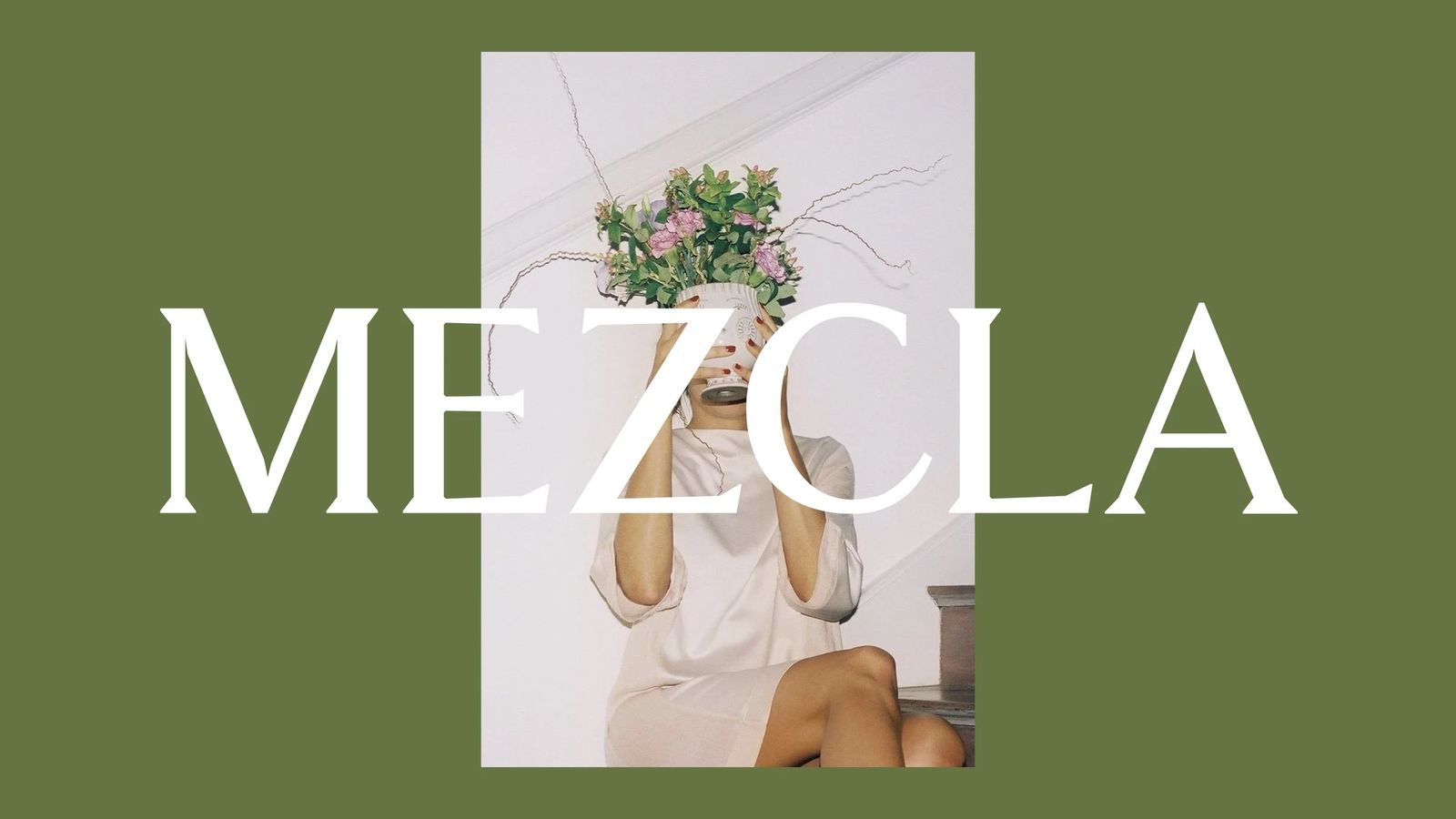 Mezcla serif wordmark in white on olive green over a photo of a figure holding flowers