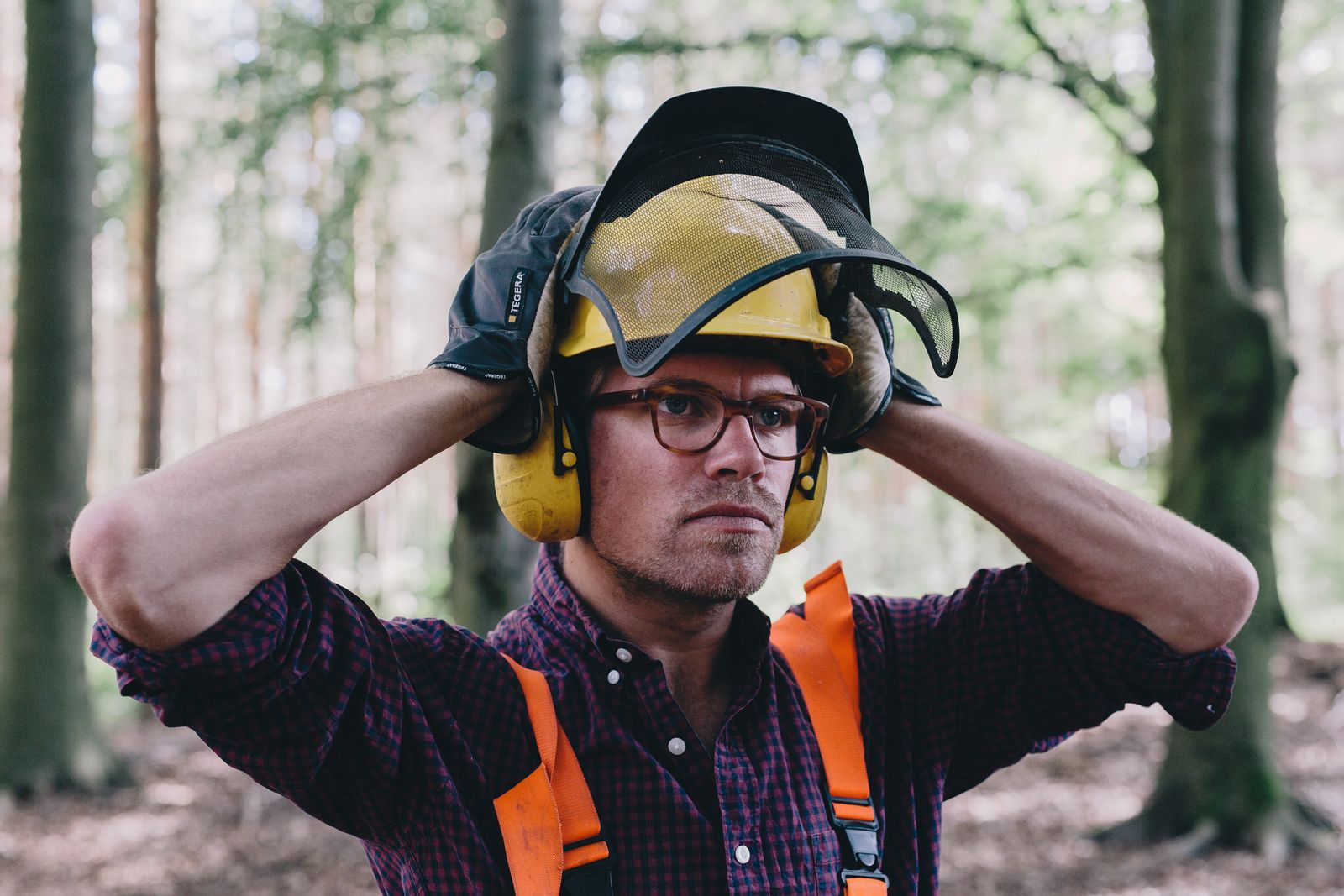 Albrecht von Alvensleben in a forestry helmet with ear defenders in a forest in Saxony-Anhalt