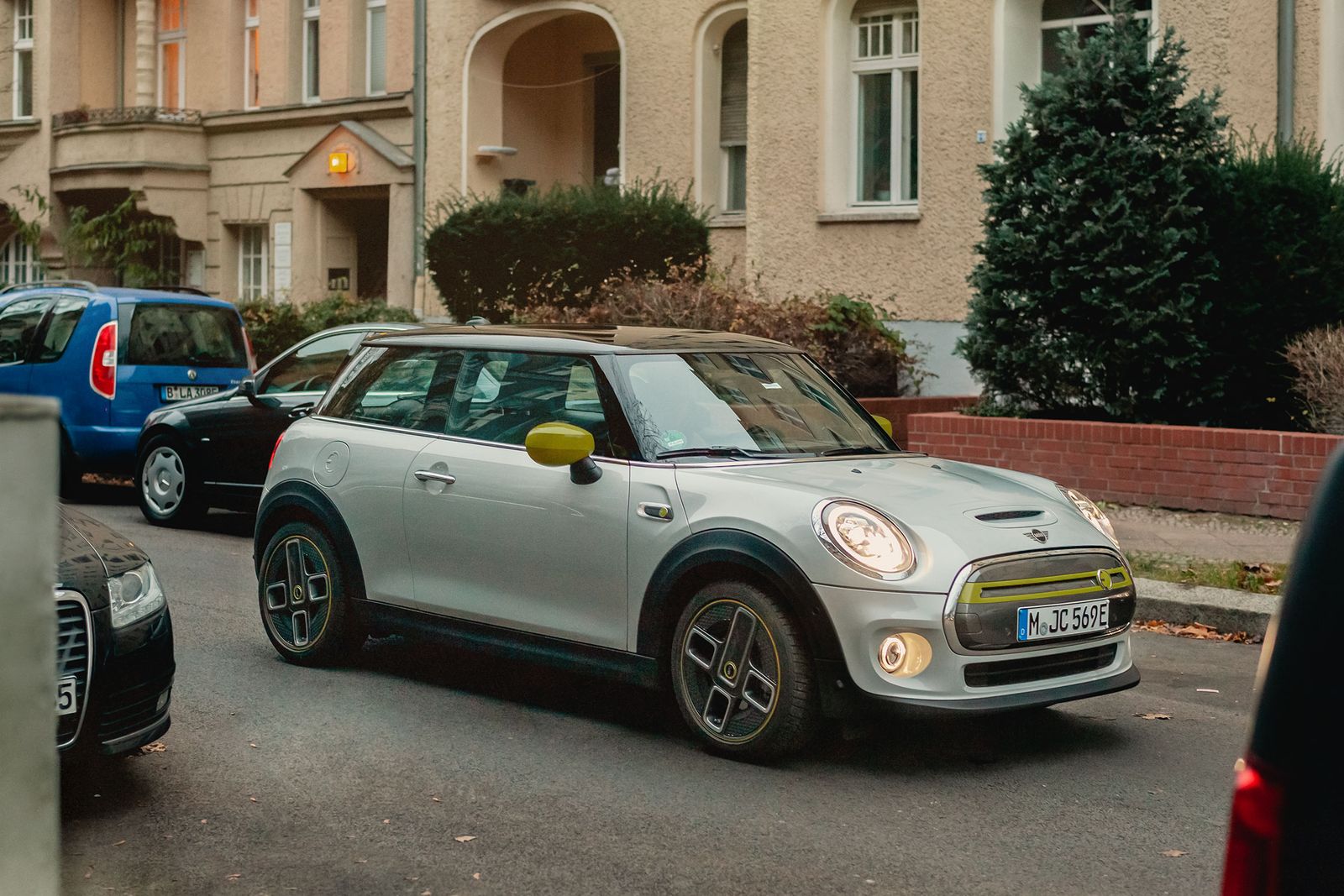 A white MINI Cooper SE parked on a residential street in Berlin