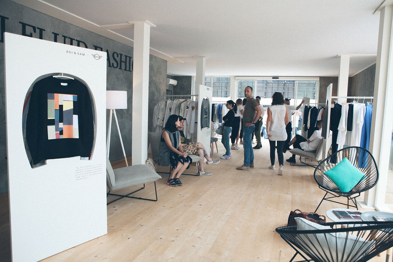 MINI Fluid Fashion exhibition at Pitti Uomo 90 with designer sweatshirts on display boards, Florence