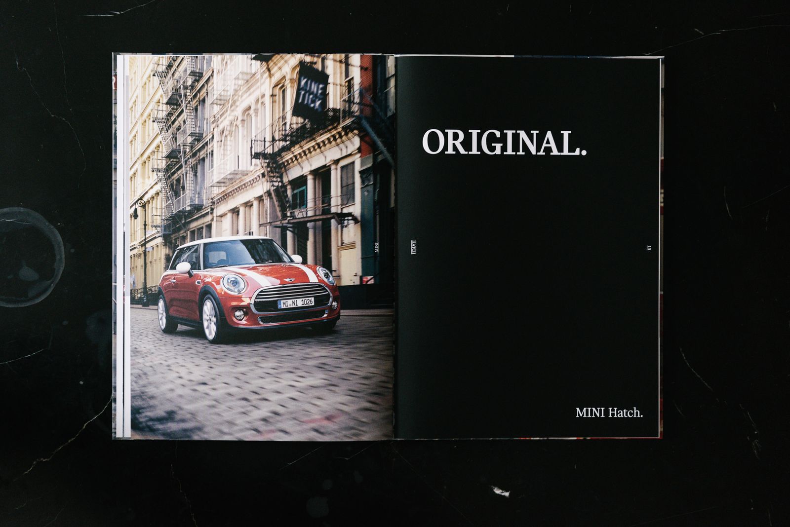 MINI Lookbook spread, Original, with a red MINI Hatch on a cobbled street