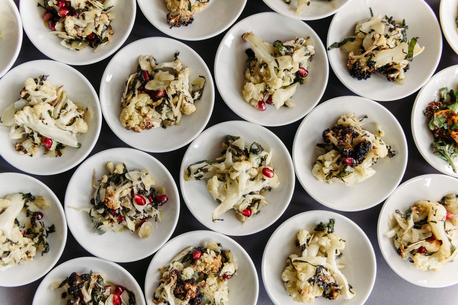 Rows of plated salads for The Sooner Now Berlin event