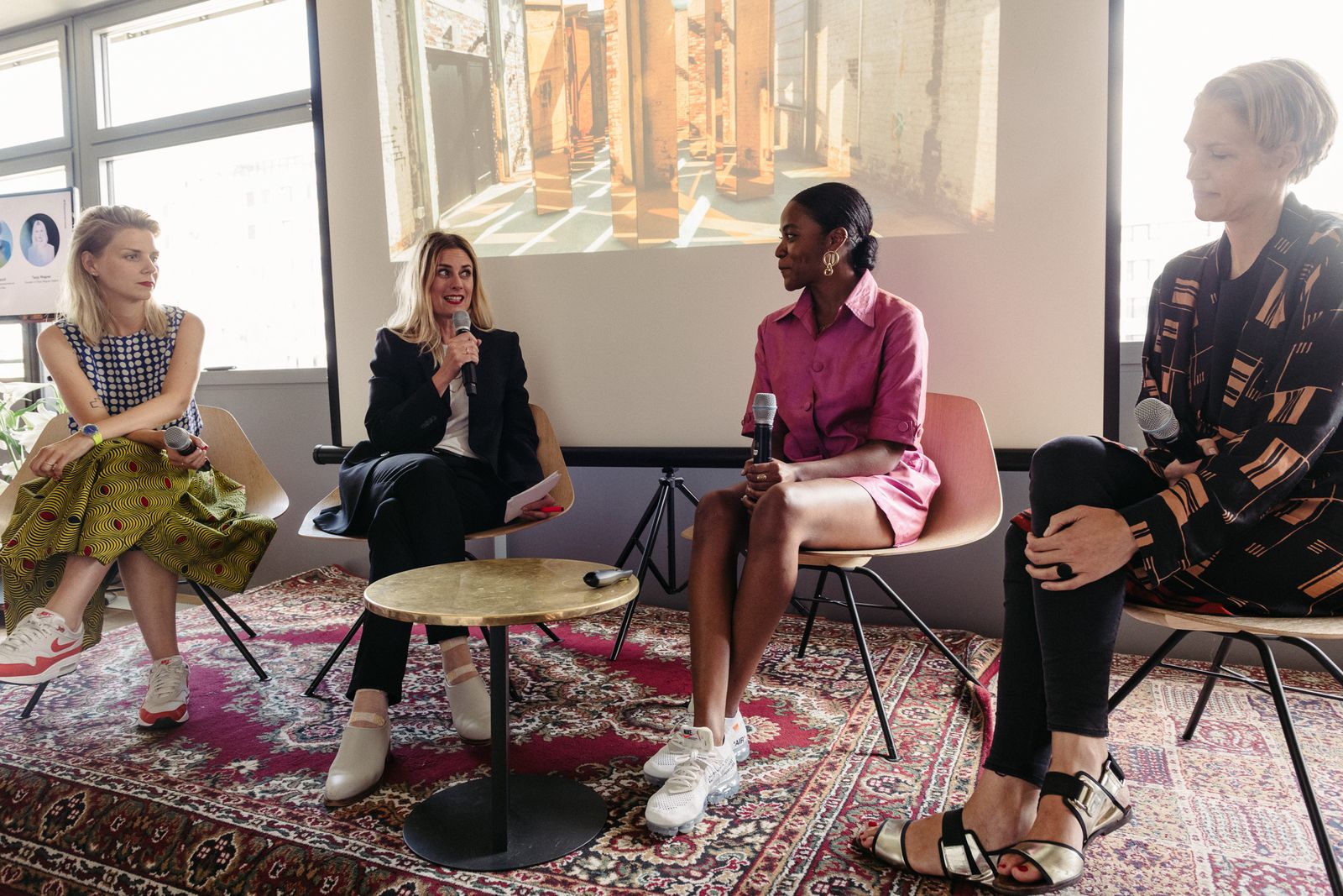 Four women in conversation on a rug-covered stage at The Sooner Now Berlin