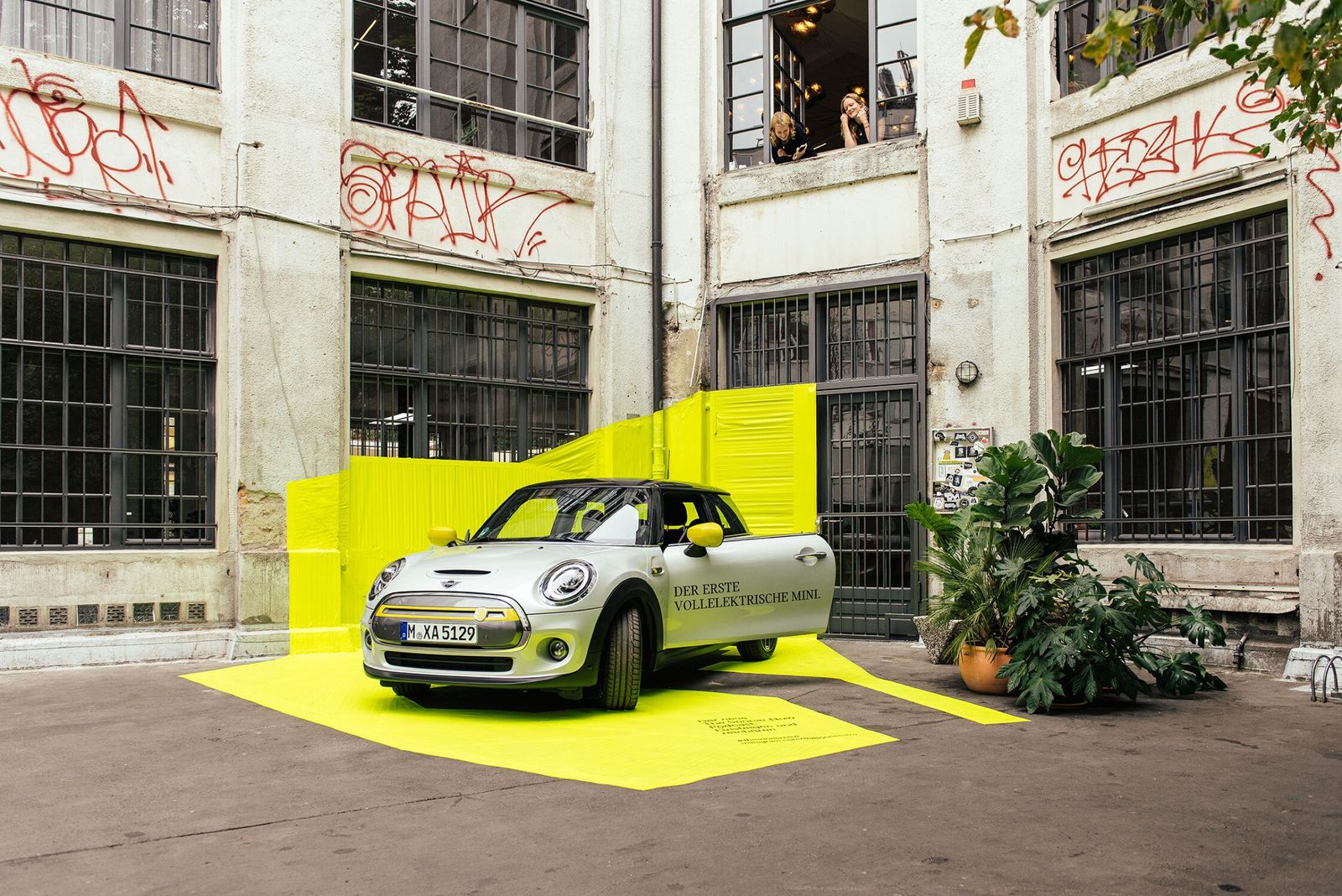 MINI Electric on neon yellow tape in a graffitied Berlin courtyard, The Sooner Now 2019