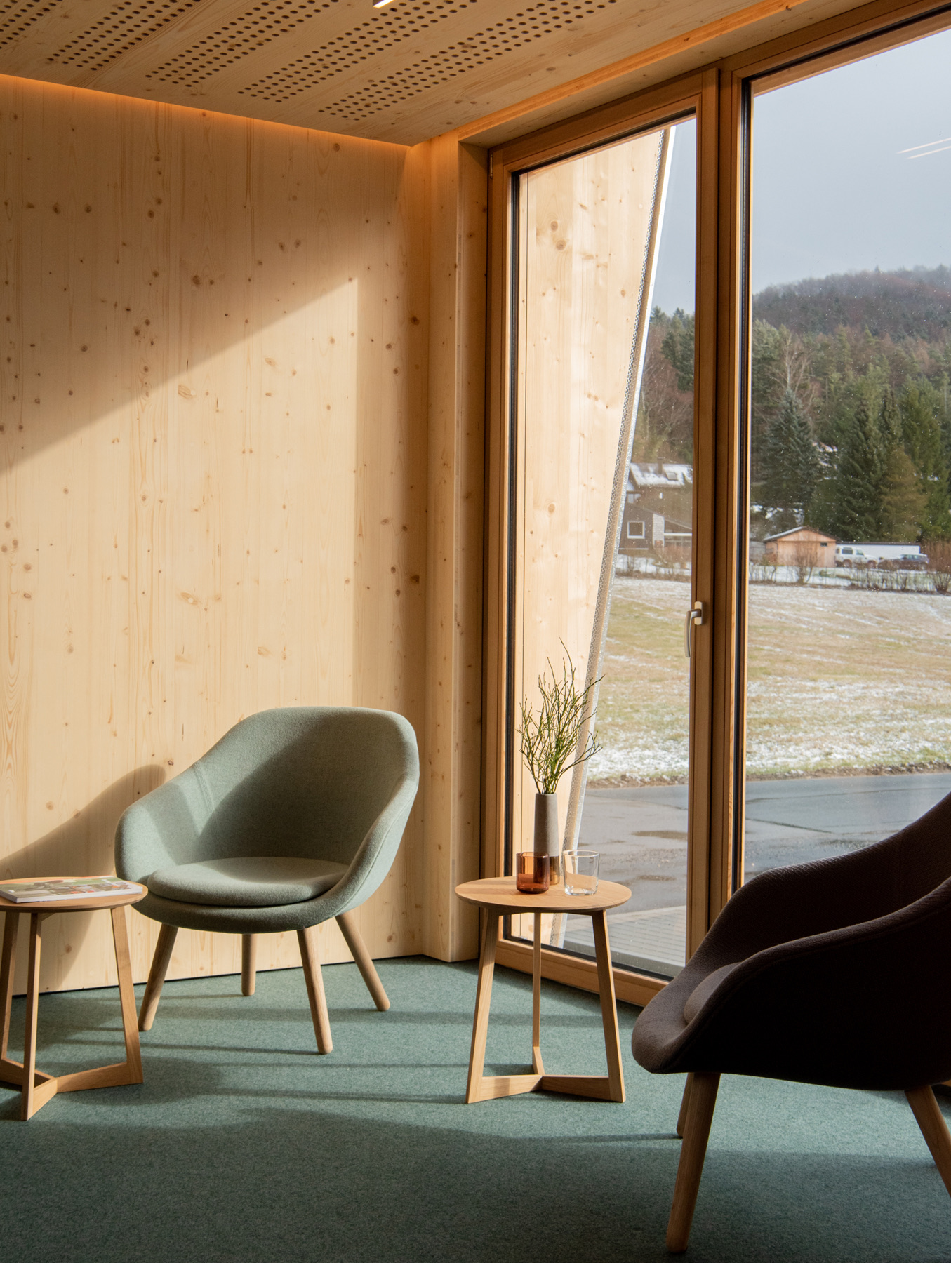 MOHAB Space interior with lounge chairs, timber walls and floor-to-ceiling windows