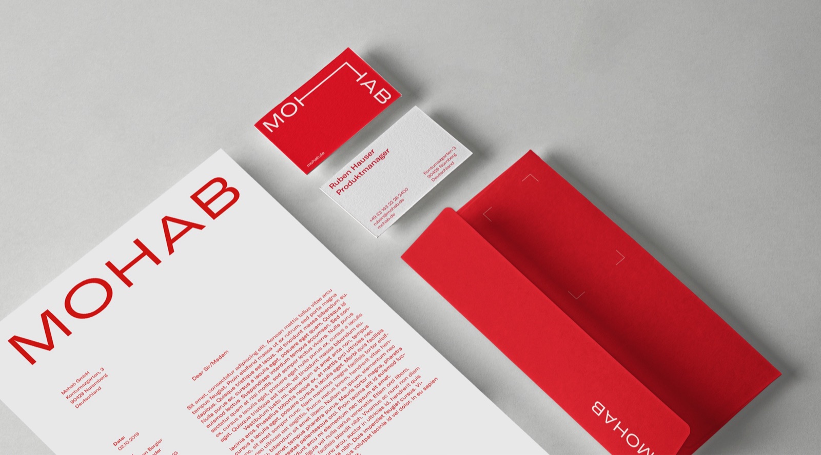 MOHAB stationery with red business cards, letterhead and envelope
