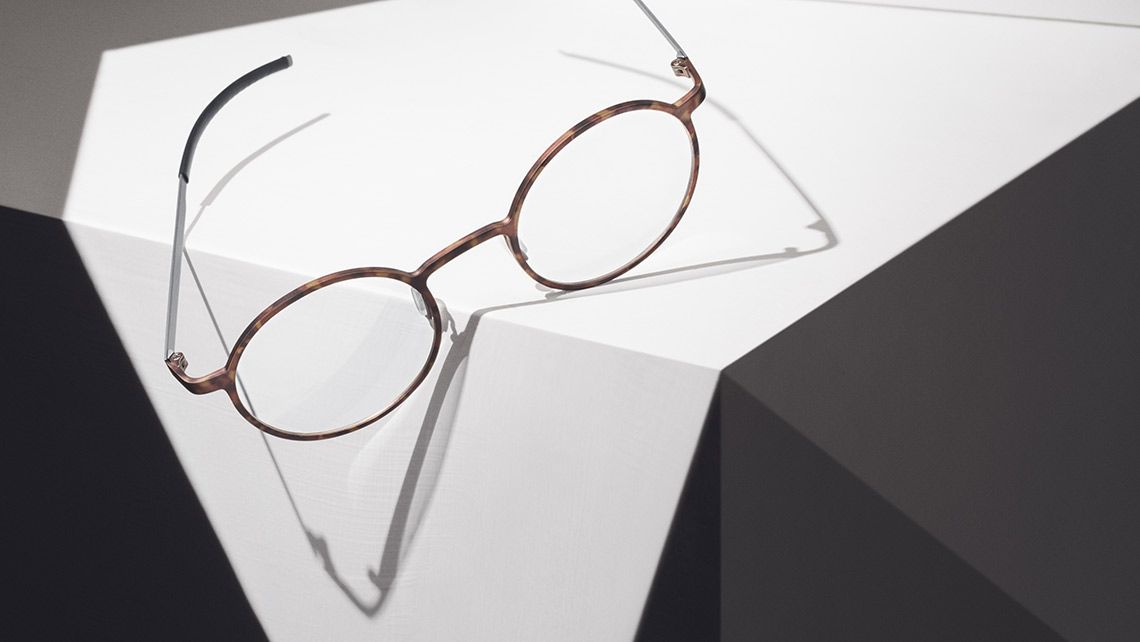 Round tortoiseshell Ørgreen frames resting on white geometric blocks
