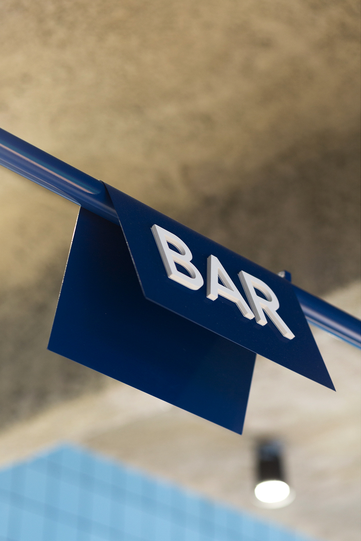 Blue ORNO bar sign hanging from the ceiling