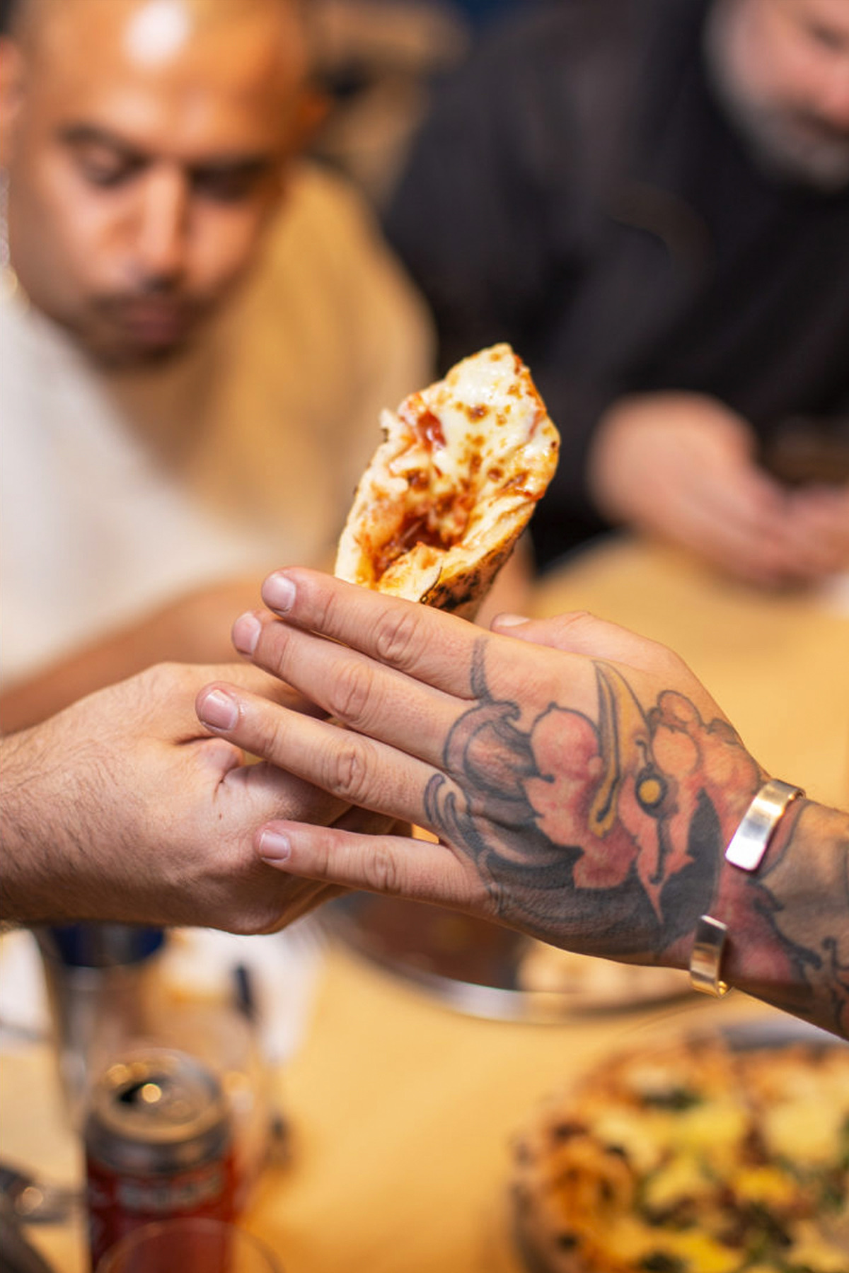 Guests sharing a slice of pizza at ORNO