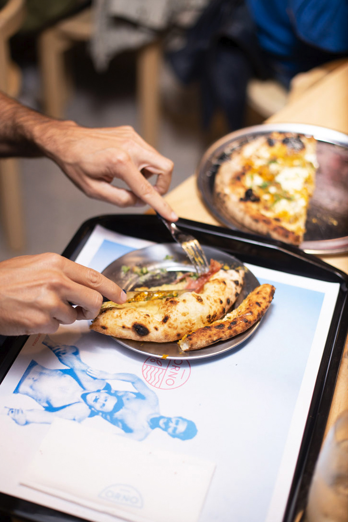 Pizza served on an ORNO branded tray
