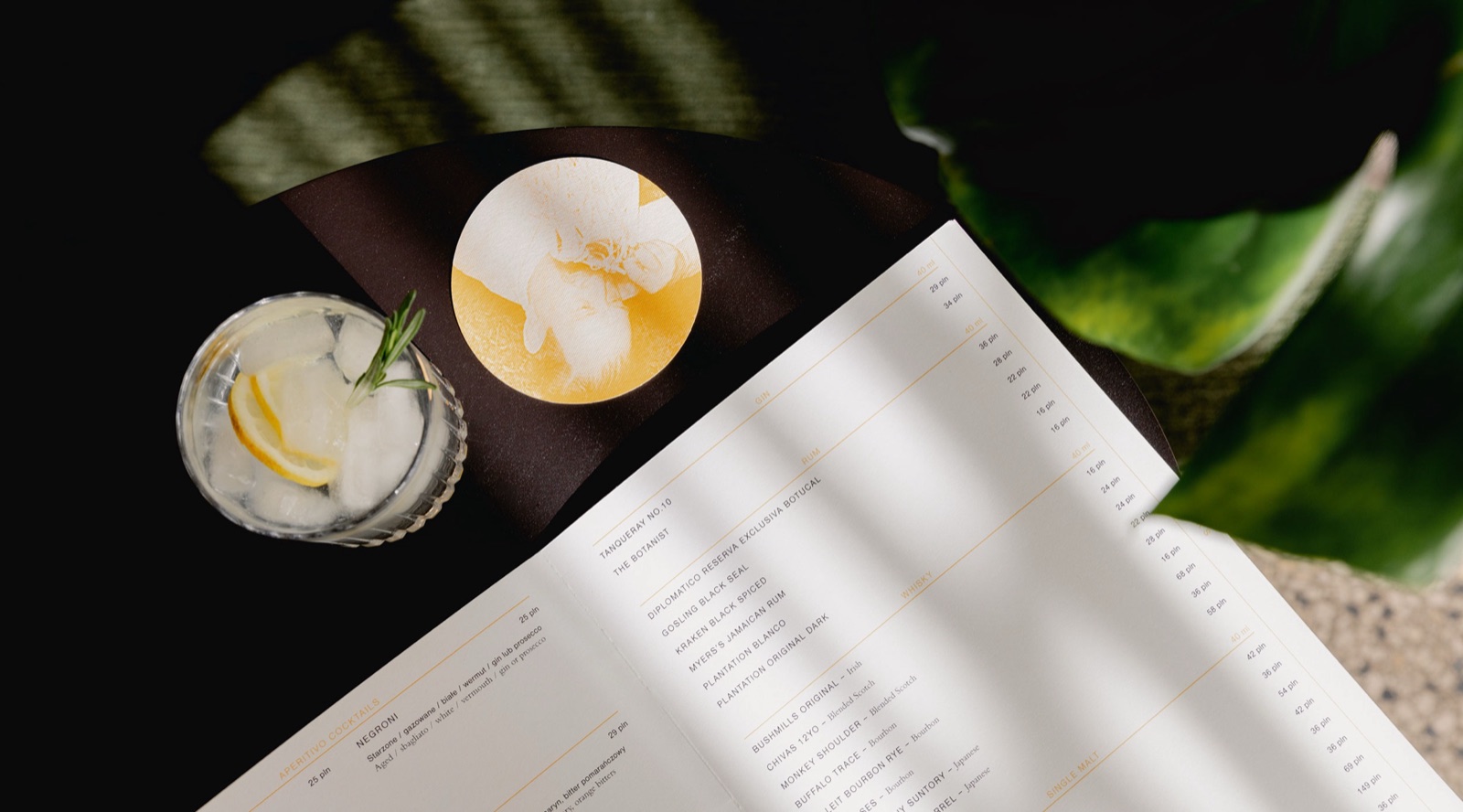 Magari menu, drink and yellow coaster on a sunlit table