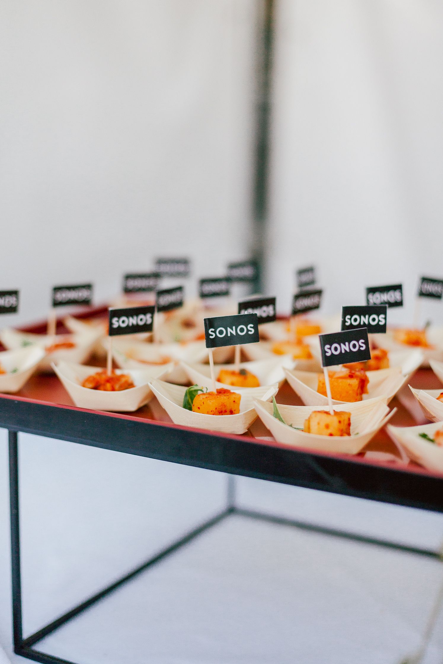 Canapés with small Sonos flags on a red platter