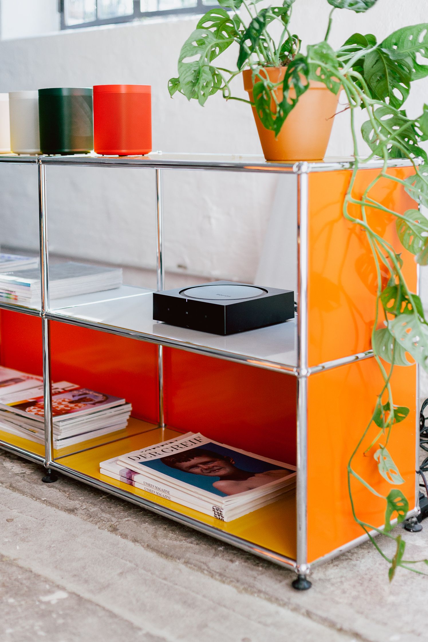 Sonos One speakers in HAY colours on an orange modular shelf at the Sonos IFA hub