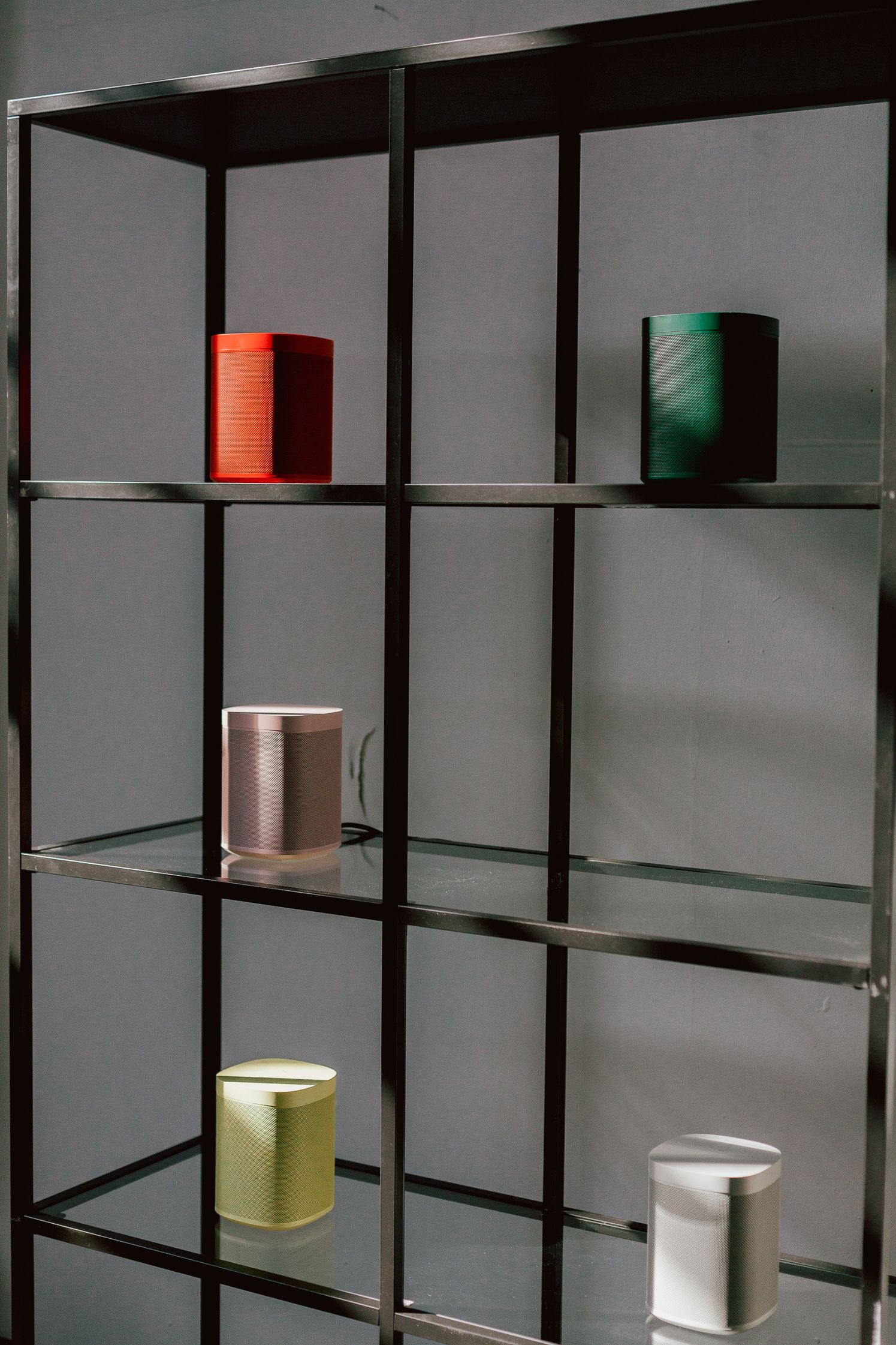 Sonos One speakers in five colours on black steel shelving at the IFA listening hub