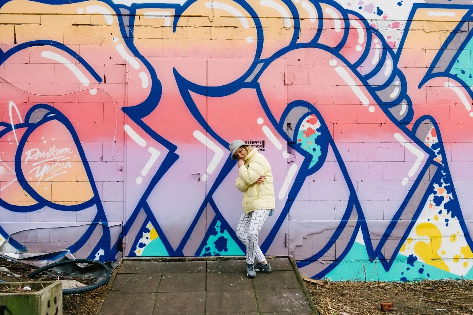 Artist standing in front of a large pink and blue graffiti mural, Sonos in-home editorial series