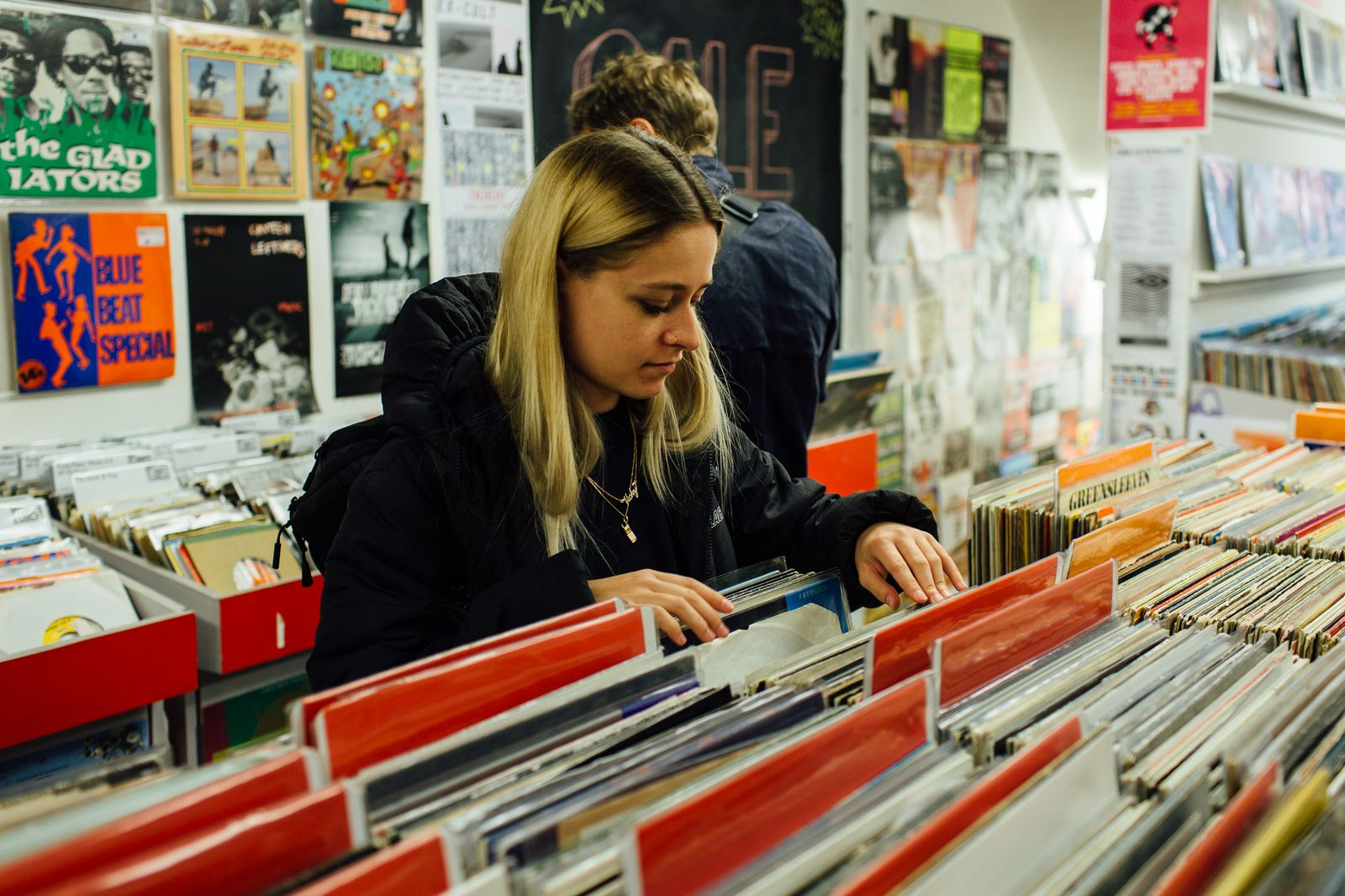 Photographer flipping through vinyl in a London record shop