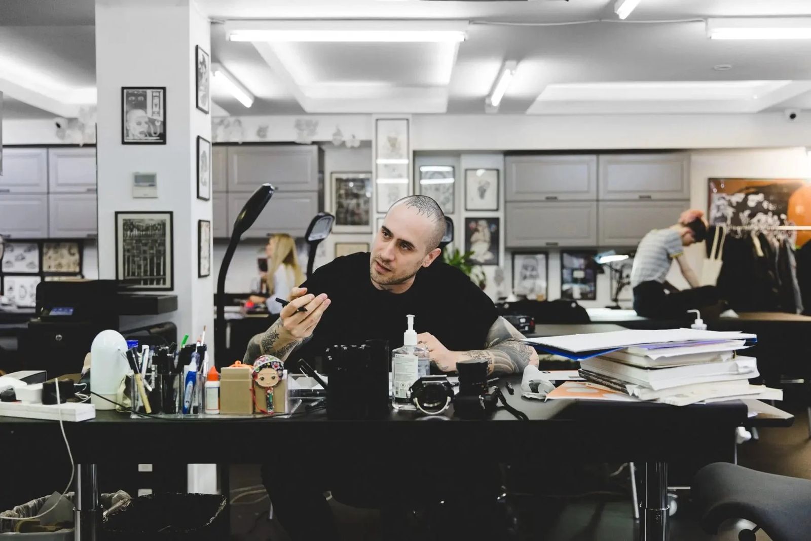 Sang Bleu founder at a desk in his studio, Sonos in-home editorial series