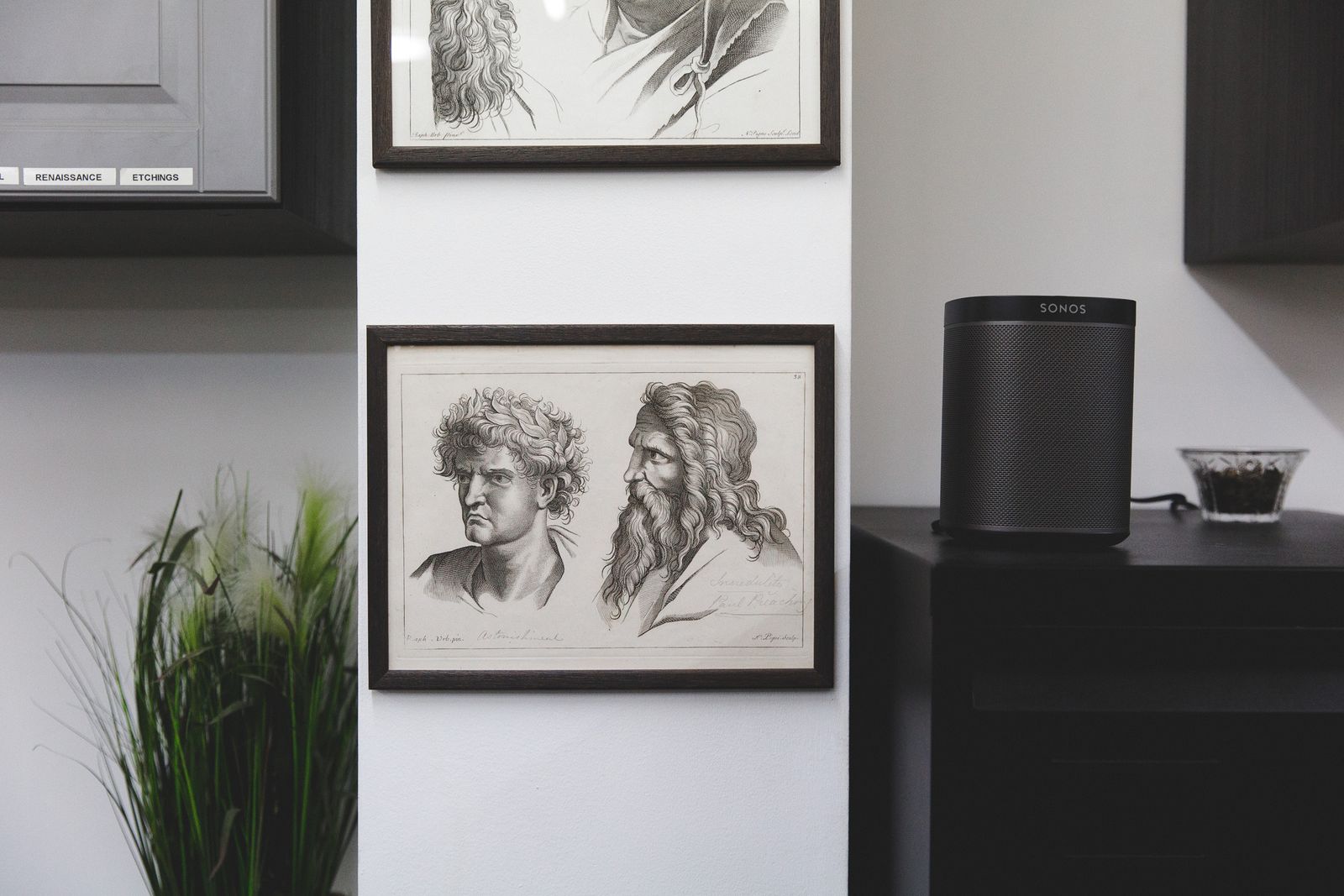 Black Sonos One on a counter beside framed drawings in a London tattoo studio