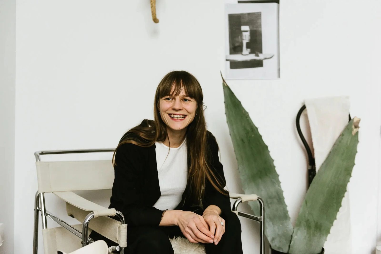 Textile designer seated in a white room beside an agave plant, Sonos in-home editorial series