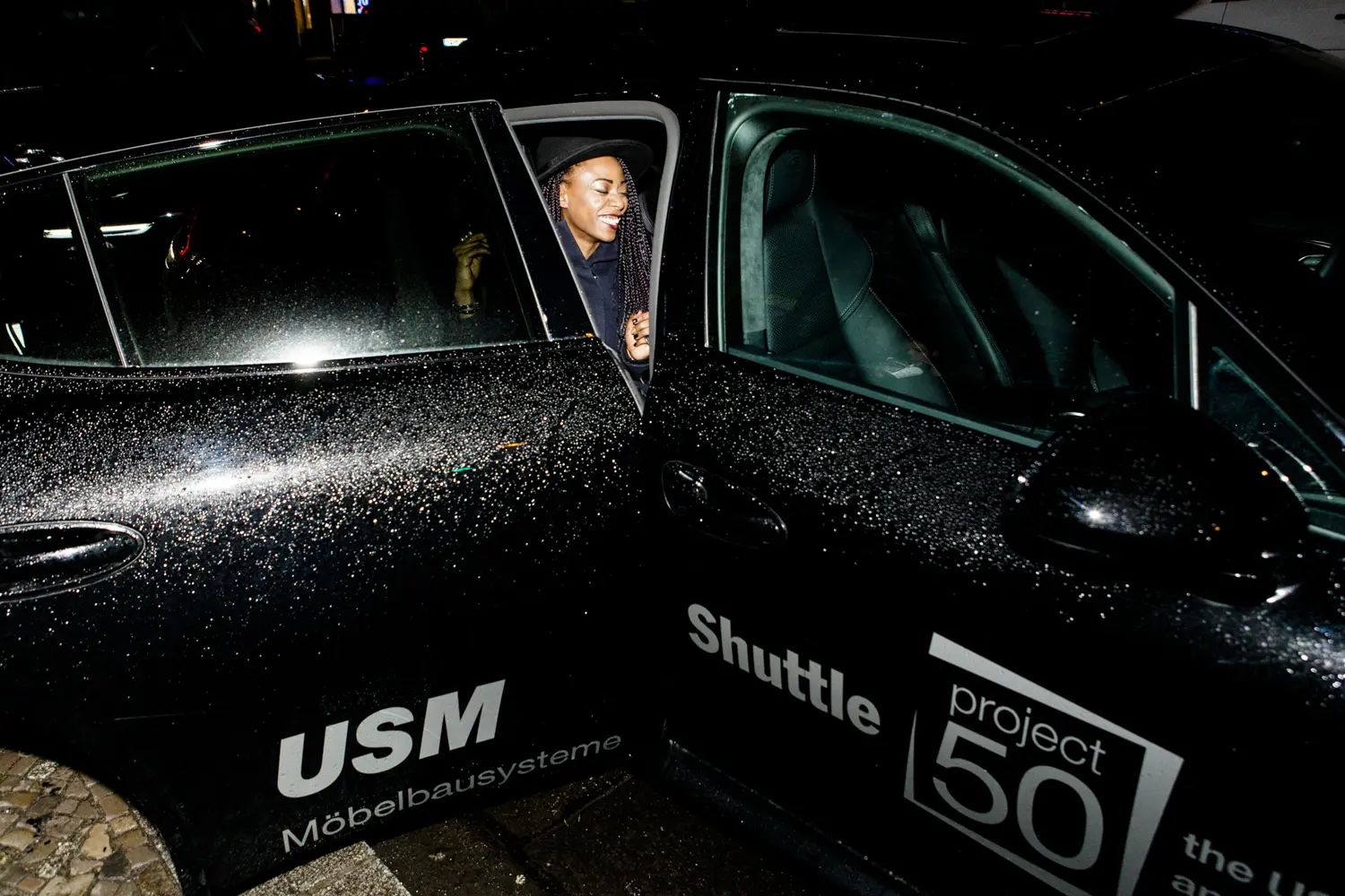 Black shuttle car branded USM project50 outside the anniversary event