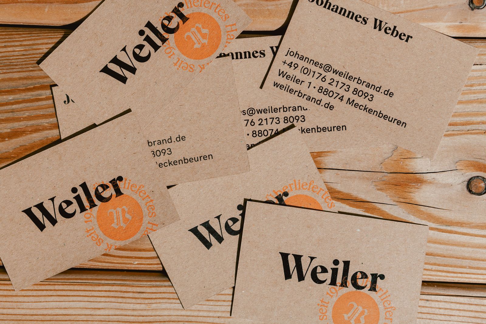 Weiler business cards on a wooden table