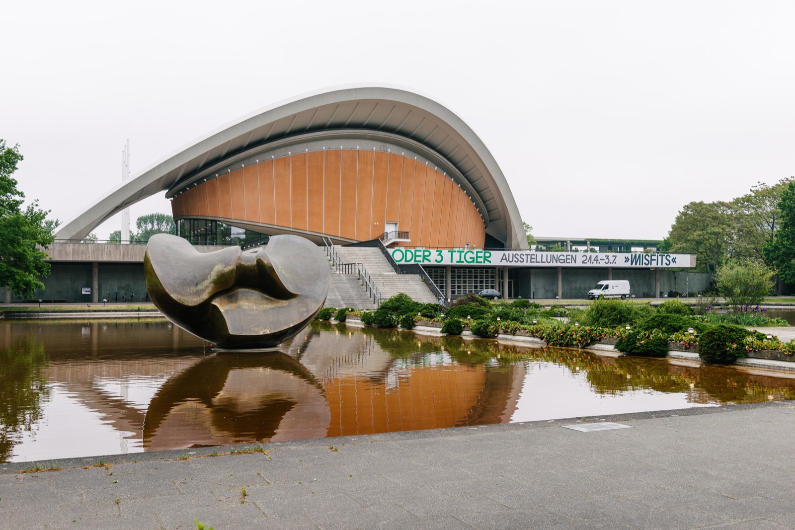 Haus der Kulturen der Welt in Berlin with its curved roof reflected in the pond, venue of TYPO Berlin 2017